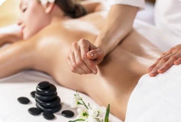 Relaxing spa back massage with hot stones